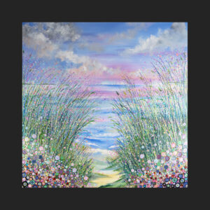 a photograph of a glass coaster which contains a fine art print of a seascape with a pink sky and lots of flowers and grasses in the foreground
