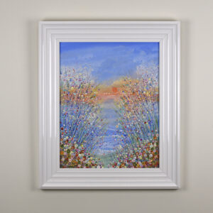 seaside painting by Isle of Wight artist Julia Tanner of flowers by the sea. The sky is orange and the flowers are in shades of yellow, white red and blue. The painting is called summer sun