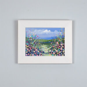 an original framed painting by Isle of Wight artist Julia Tanner of a flower meadow and a cottage by the lake
