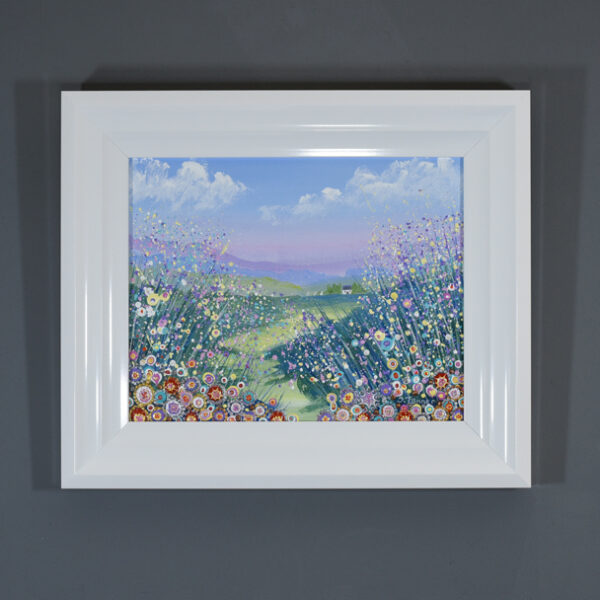 original flower landscape painting by Isle of Wight artist Julia Tanner. It features a cute cottage in the countryside by a lake with yachts. There are foreground flowers in shades of pink, lilac and lemon with lots of detail